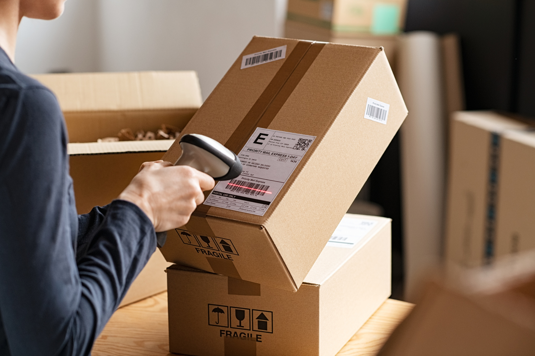 Person Scanning Parcel Barcode Before Shipment